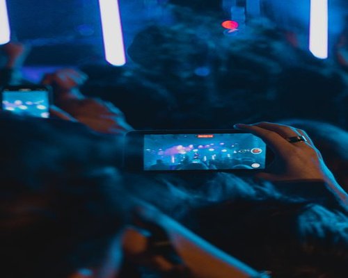Central smartphone showing a PrimeCrownPlay event guide